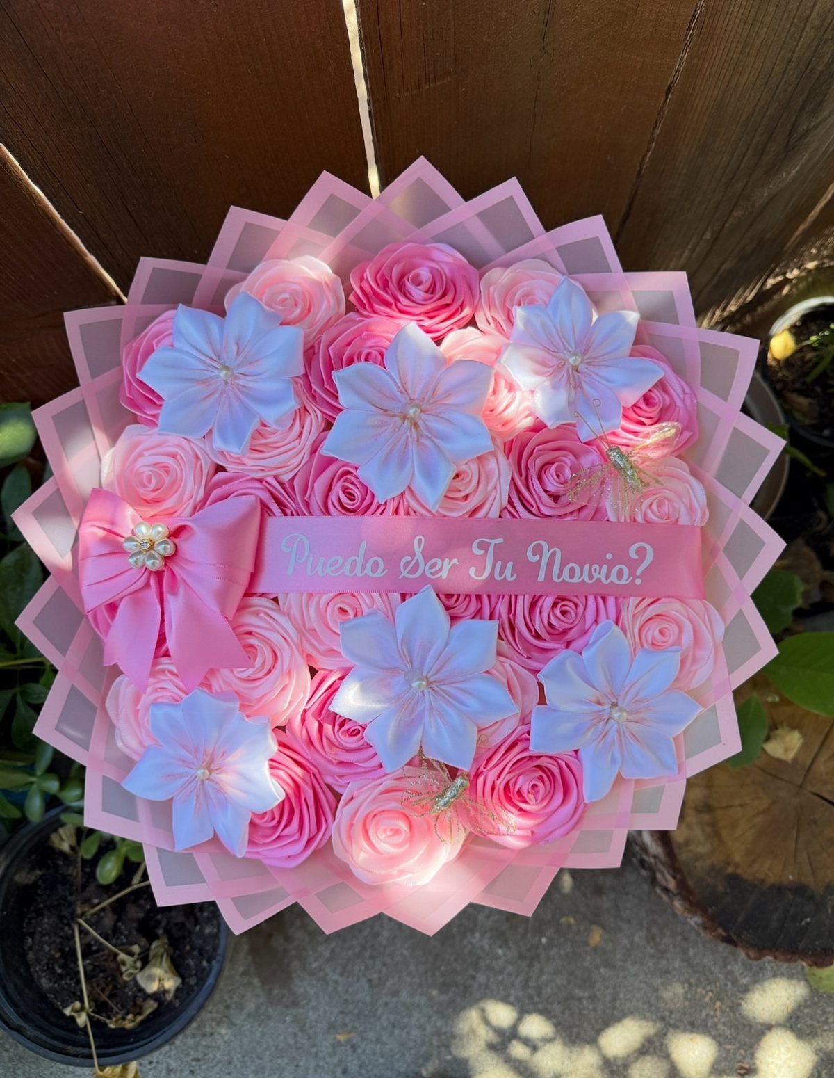 Pink and white artificial flower bouquet with a ribbon asking to be a boyfriend