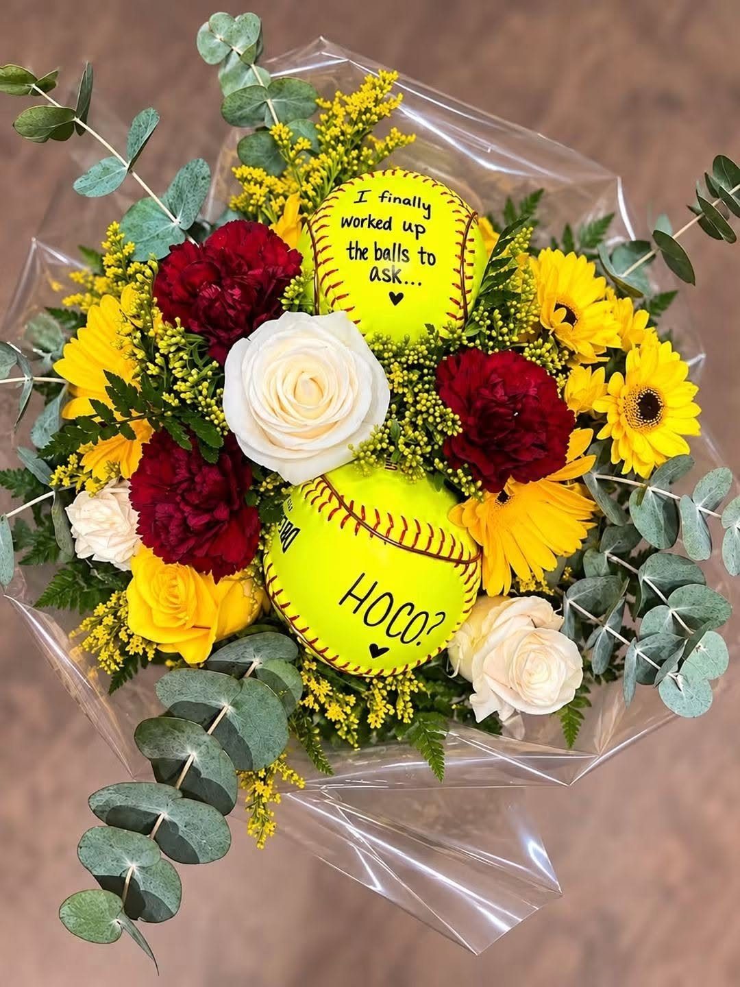 Floral bouquet with yellow softballs, roses, and carnations for a homecoming proposal.
