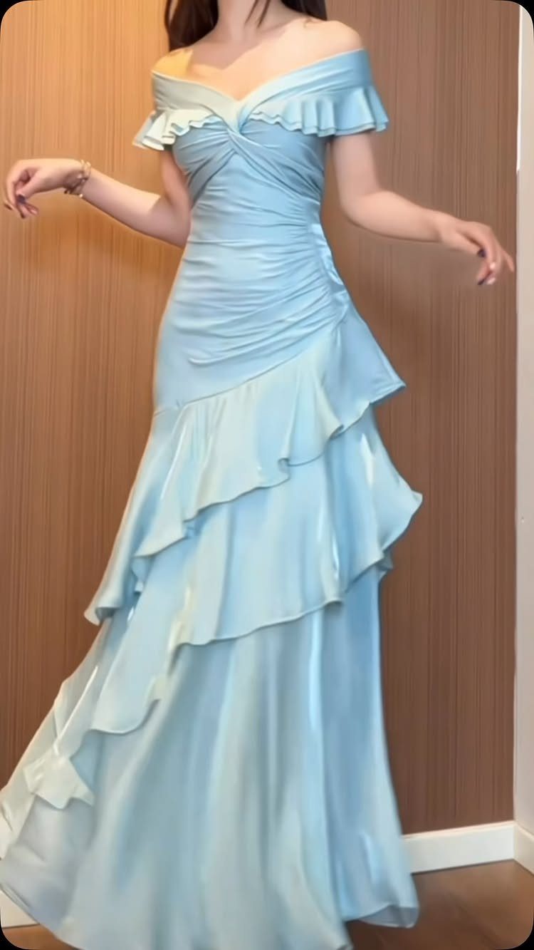 Light blue off-the-shoulder prom dress with ruffles and a tiered satin skirt.