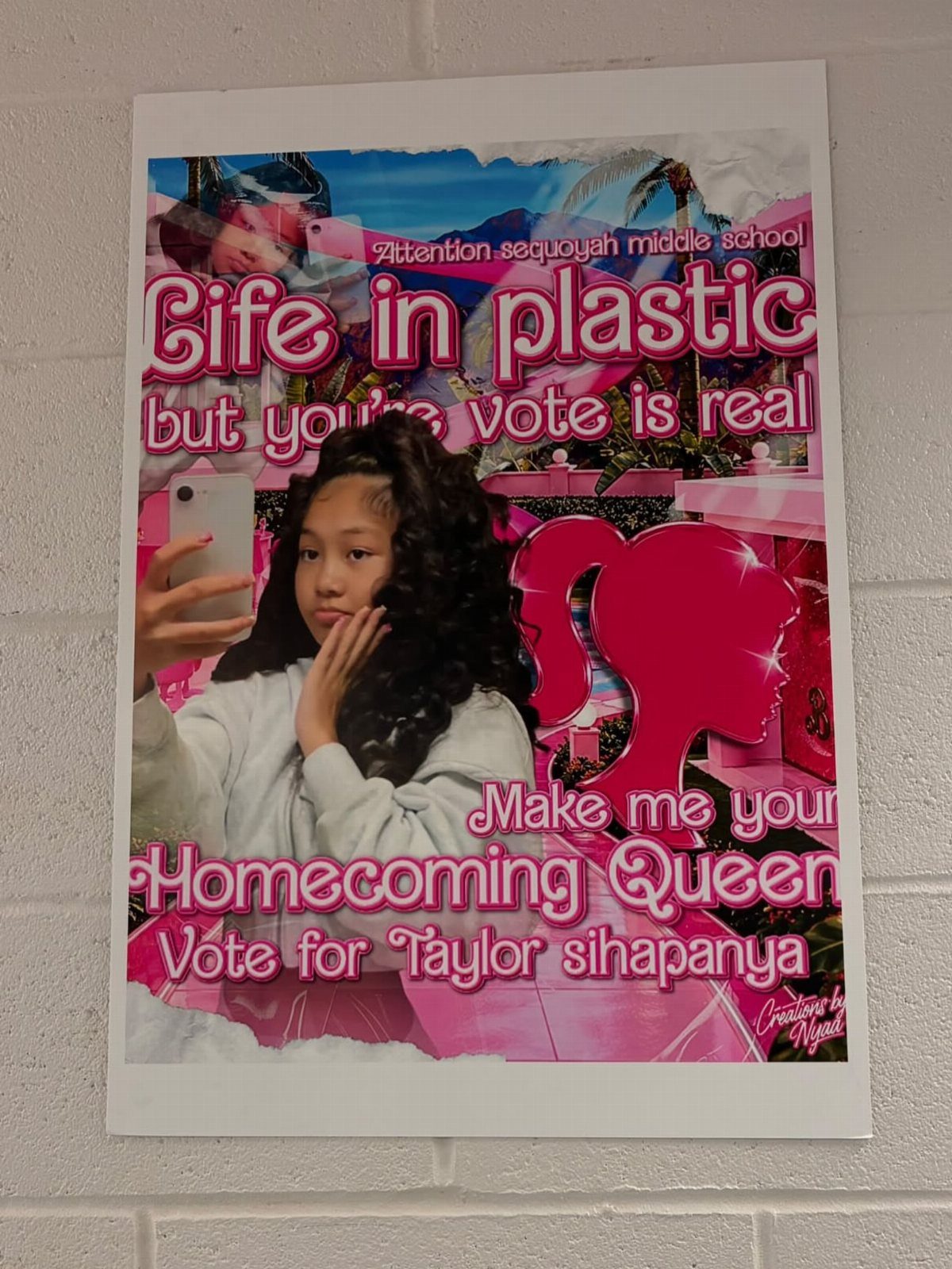 Homecoming campaign poster with a girl's photo and pink stylized text on brick wall