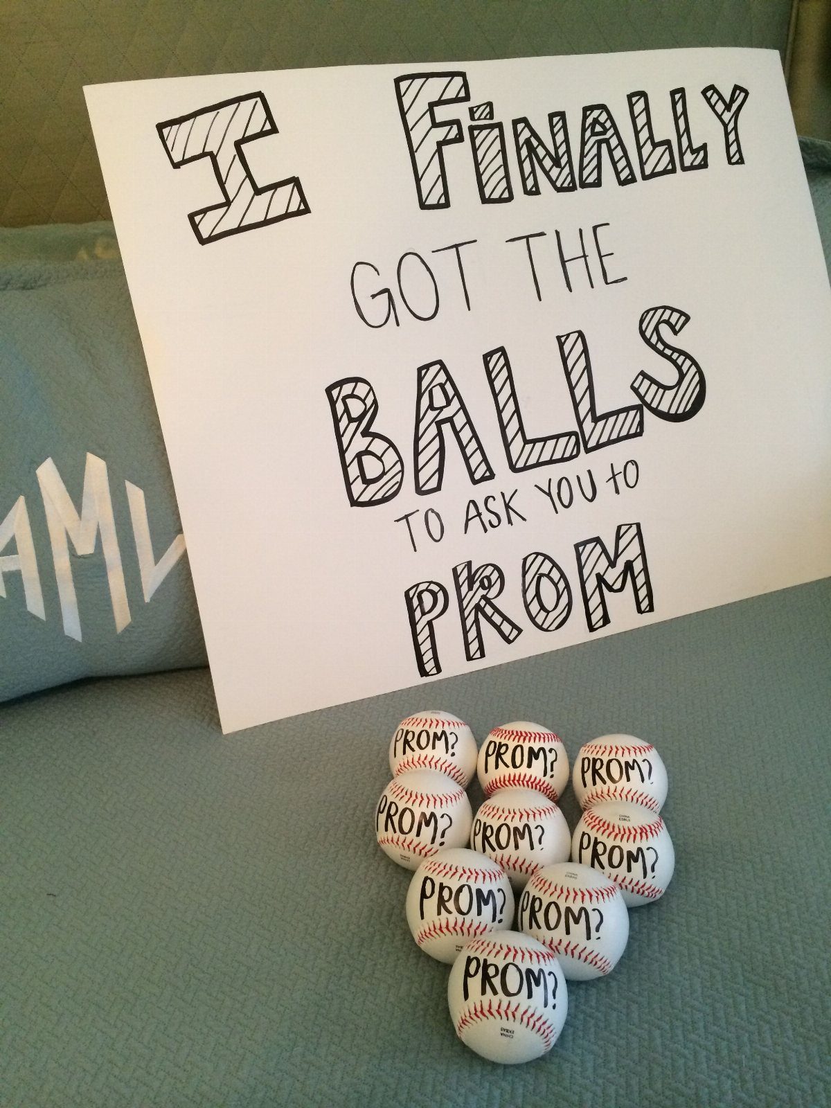 Promposal poster with baseballs and text asking someone to prom on teal fabric