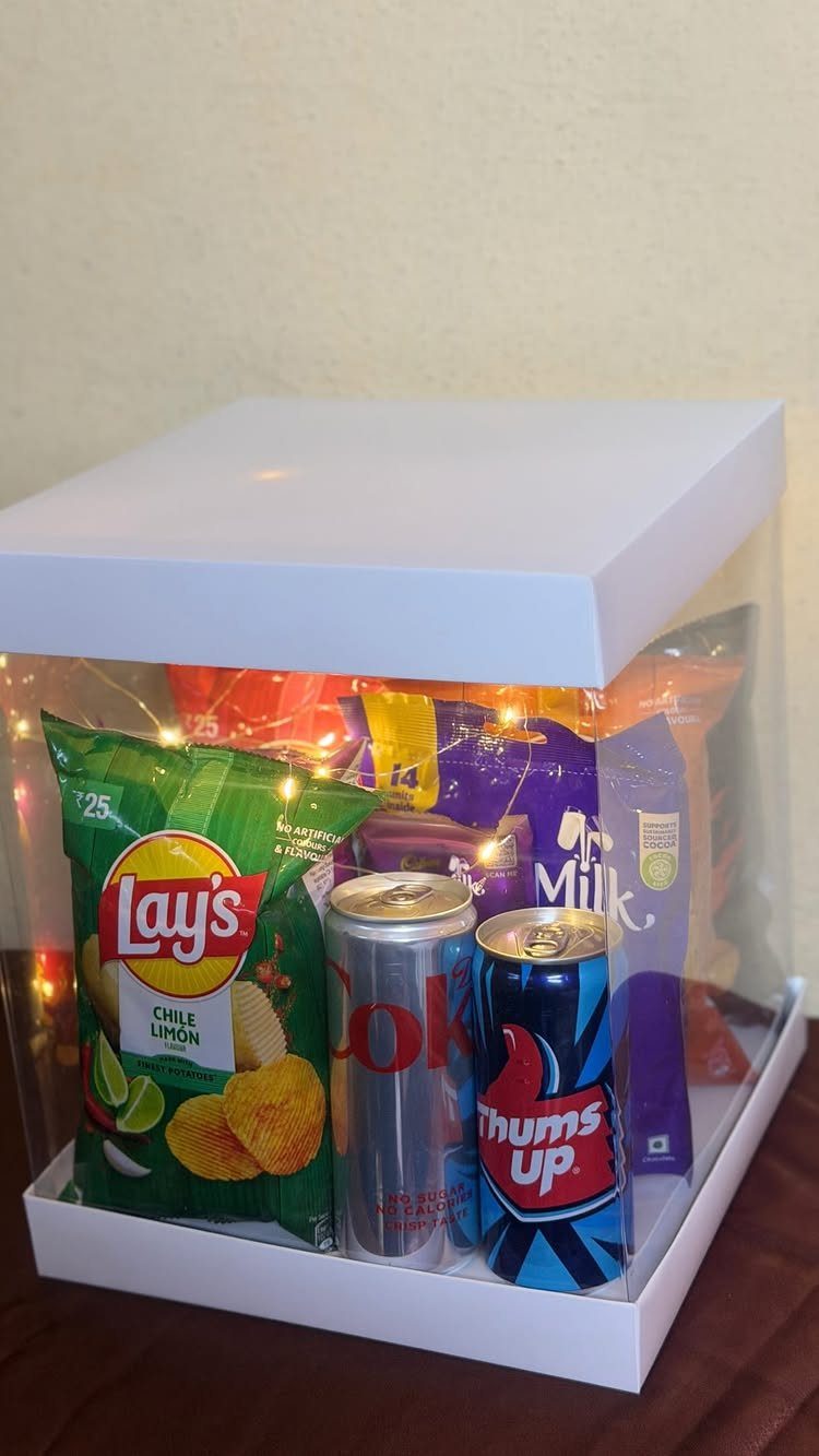 Gift box filled with snacks and fairy lights for a homecoming proposal.