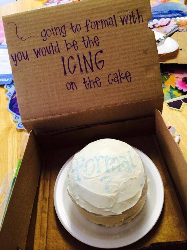 Small white cake in a cardboard box with a handwritten formal proposal message.