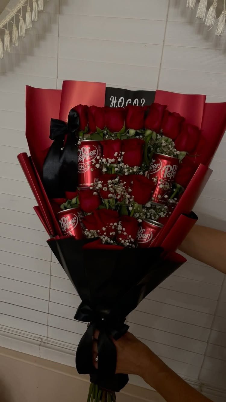 Bouquet of red roses and mini Dr Pepper cans wrapped in red and black.