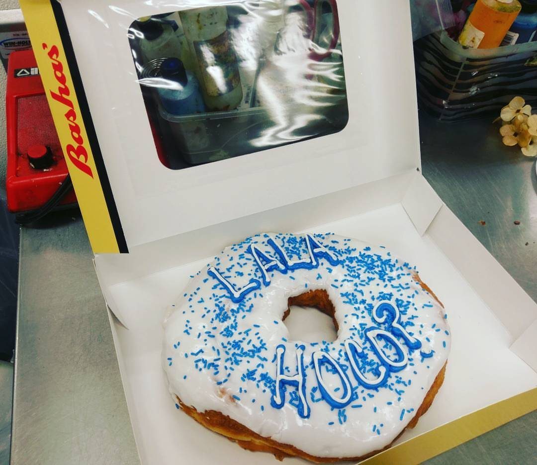 White frosted donut with blue sprinkles and HOCO proposal text in a box