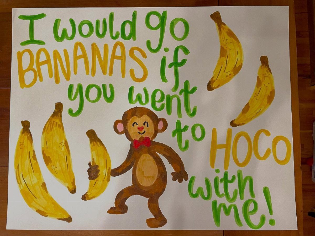 Hand-painted homecoming proposal poster with a cartoon monkey and bananas on white board.