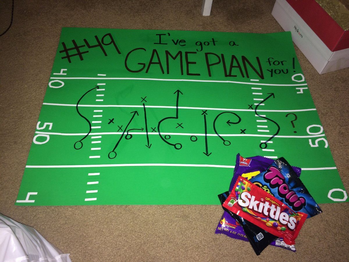 Football field themed proposal poster with sports puns and colorful candy bags.