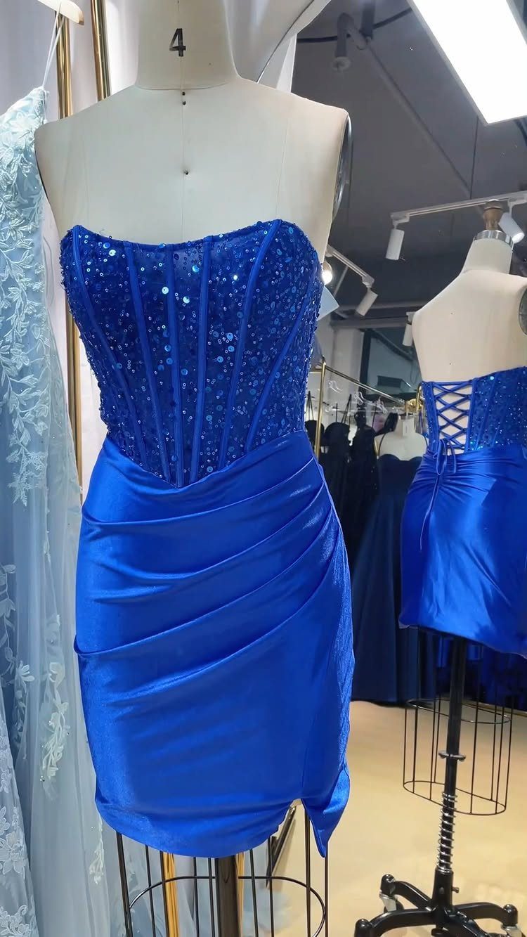 Royal blue strapless cocktail dress with sequined bodice and draped satin skirt on mannequin