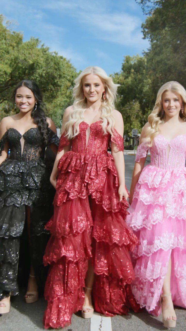 Three young women wearing long, tiered sequined formal gowns in black, red, and pink.
