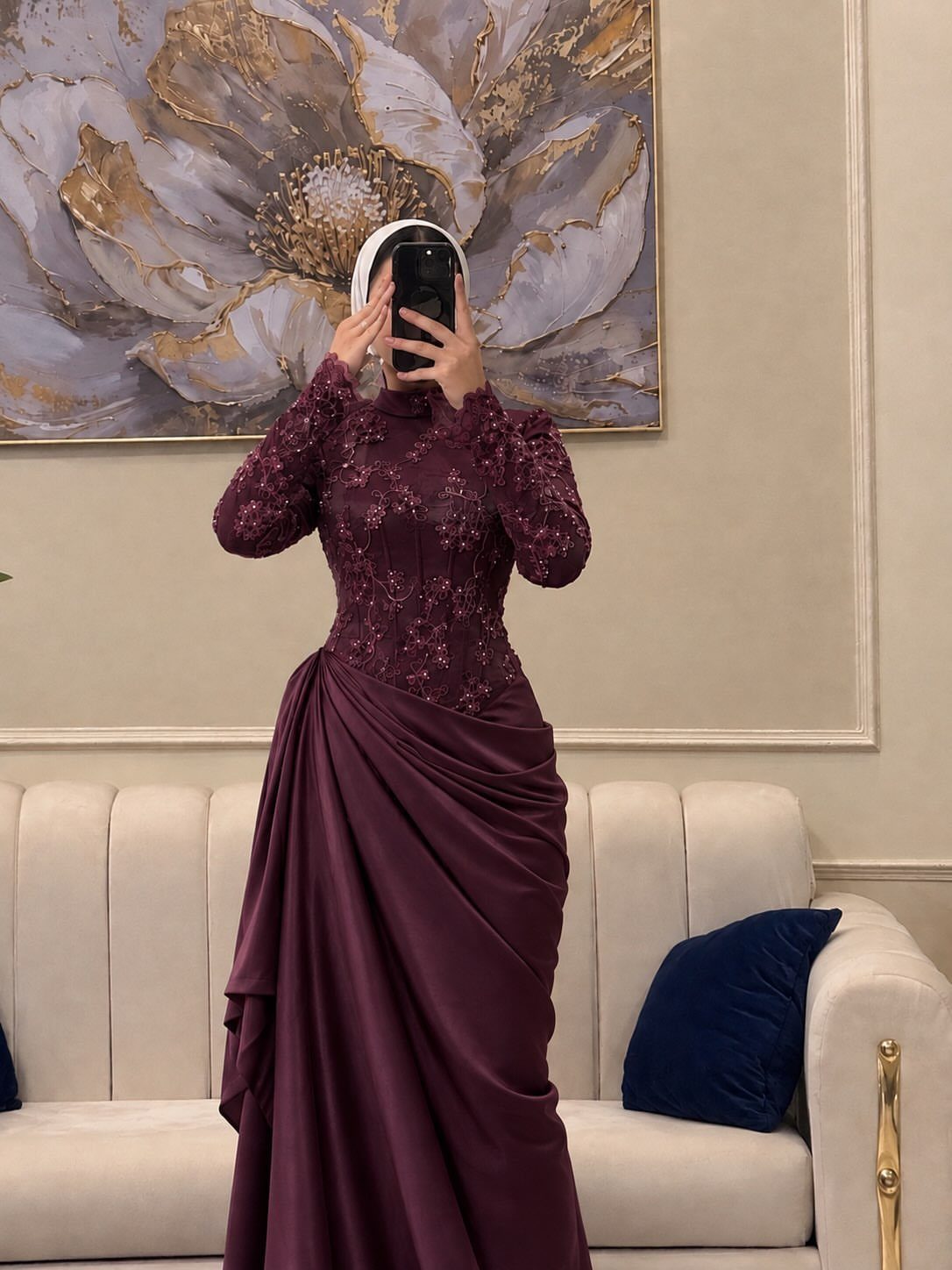 Person in a modest plum-colored long-sleeved gown with lace bodice and satin skirt.
