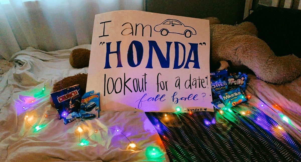 Homecoming proposal sign with a car pun, candy, and colorful string lights.