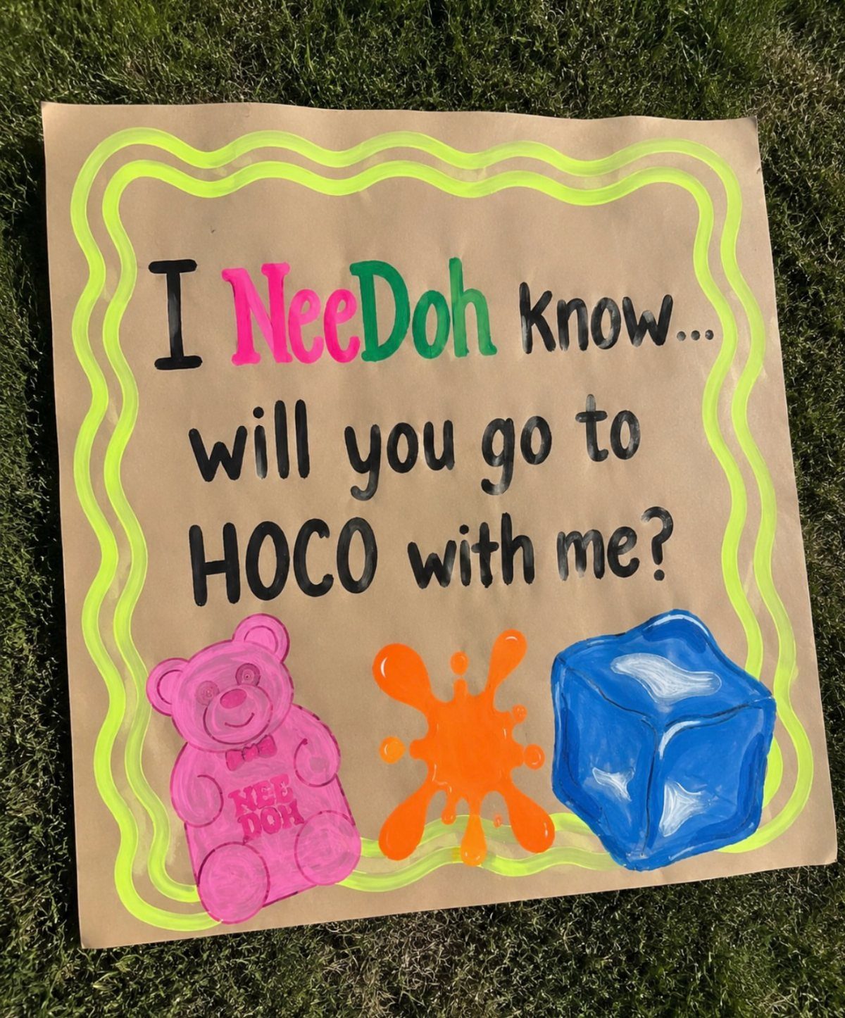Handmade homecoming proposal sign on cardboard with colorful text and drawings on grass
