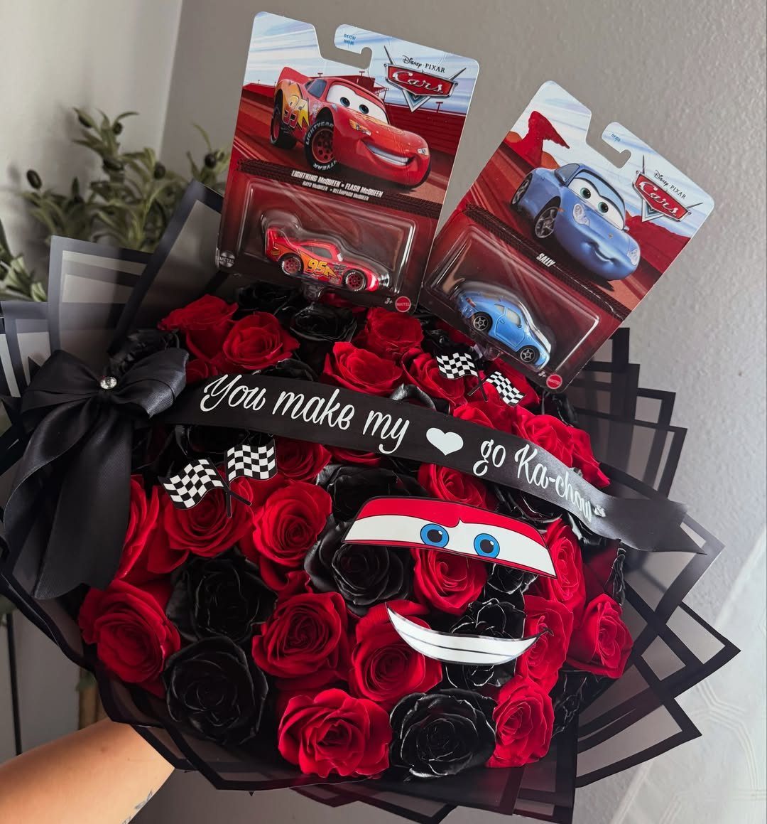 Rose bouquet with Lightning McQueen toy cars and a promposal ribbon.