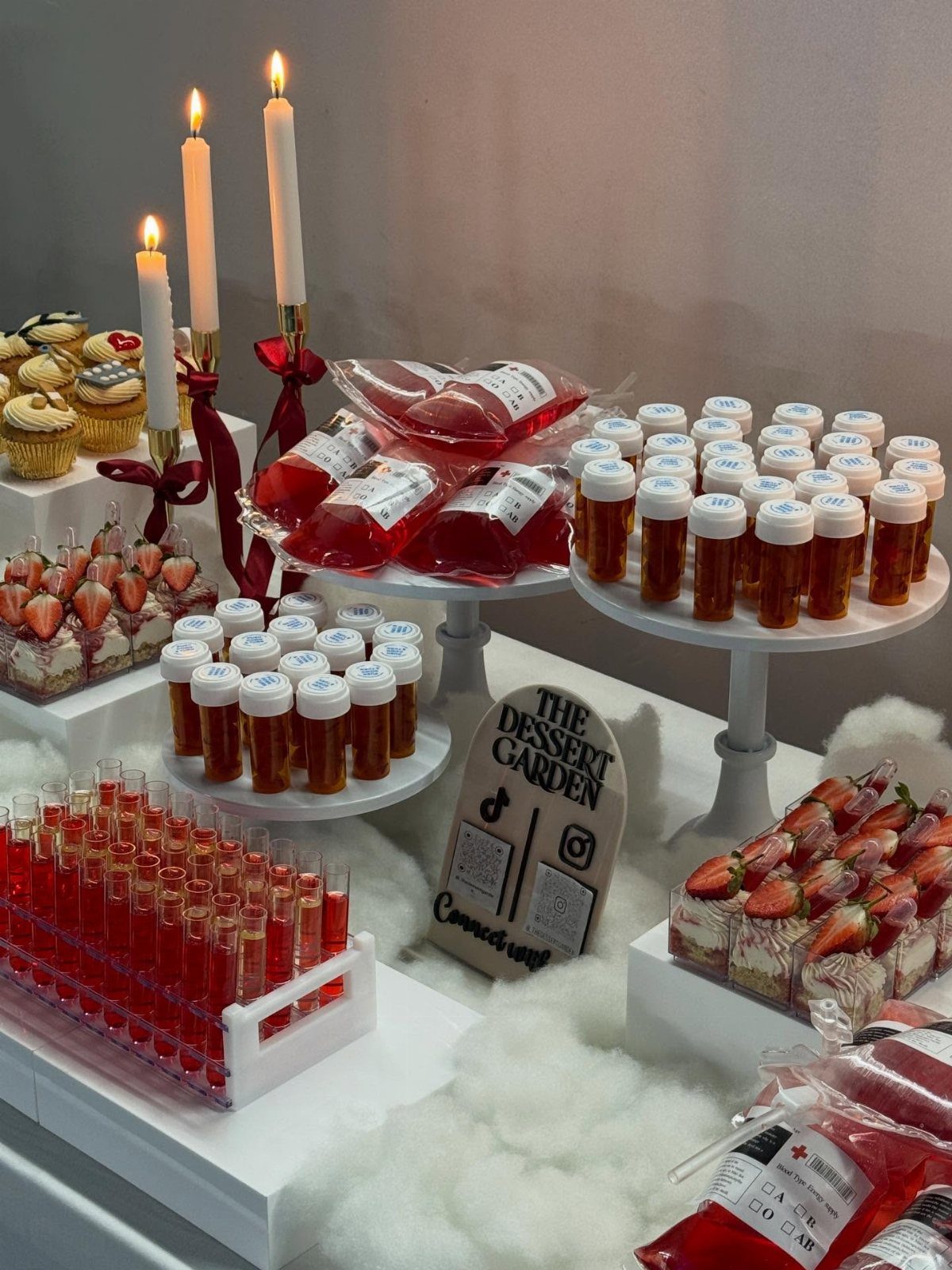 Nursing-themed party dessert table with IV bags, test tubes, and medicine bottle treats.
