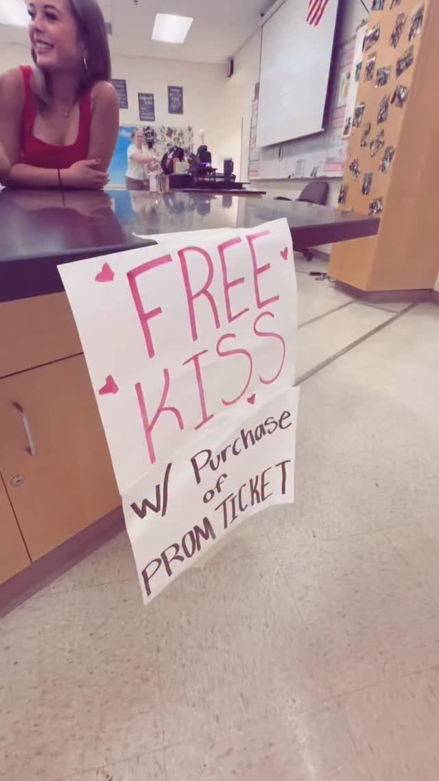 Handmade prom asking poster offering a free kiss with a prom ticket purchase.