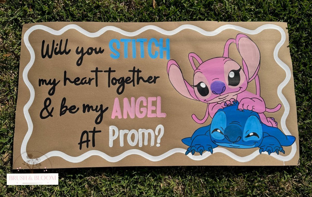 Hand-painted promposal poster with Stitch characters on brown cardboard resting on green grass.