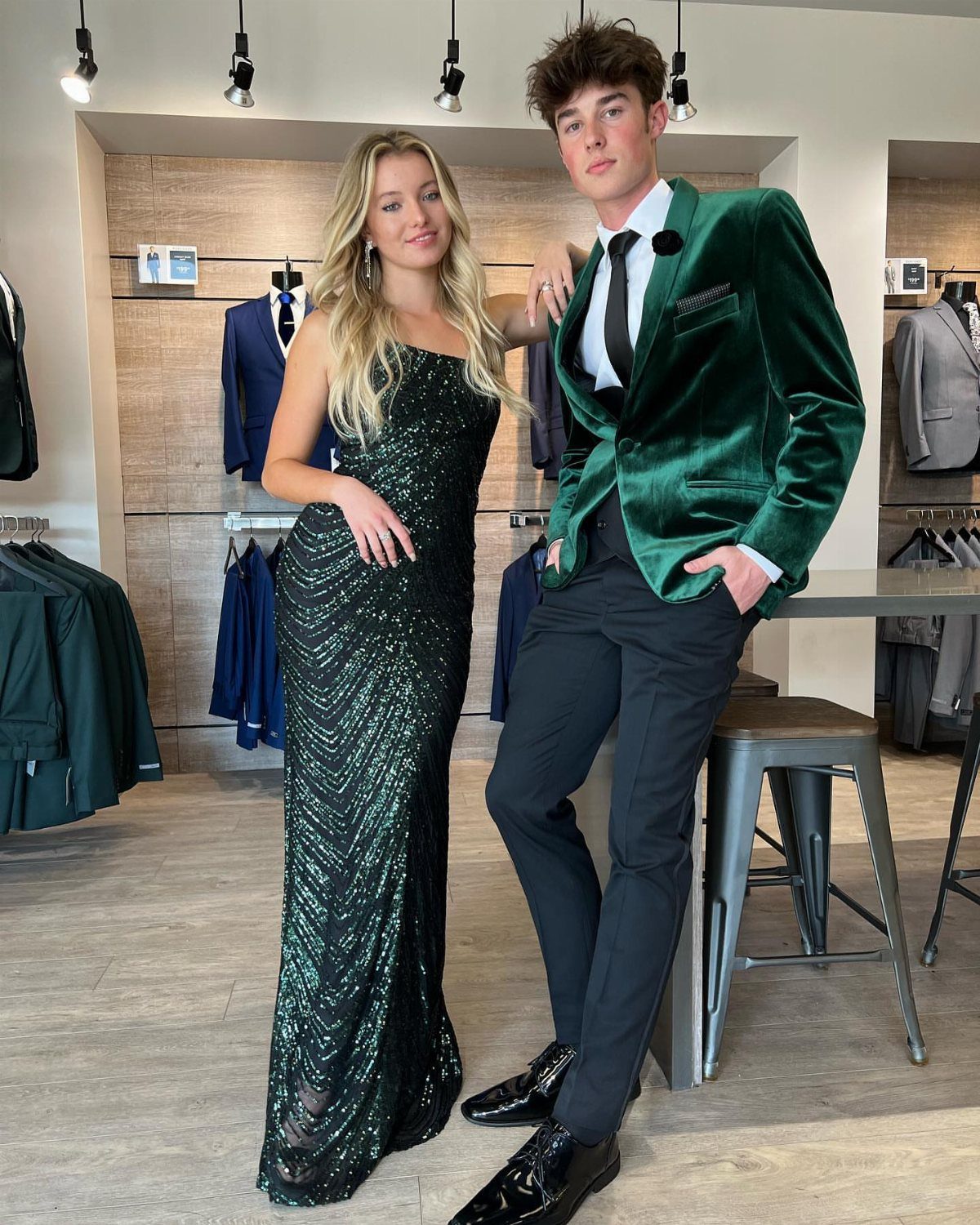 Young man in green velvet dinner jacket and tuxedo pants with a woman.