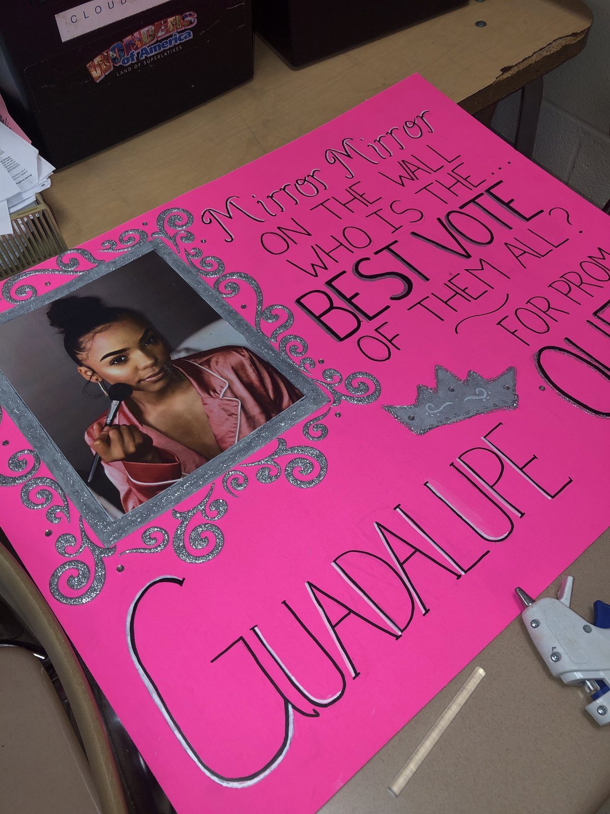 Pink prom queen campaign poster with a photo of a girl and silver glitter.