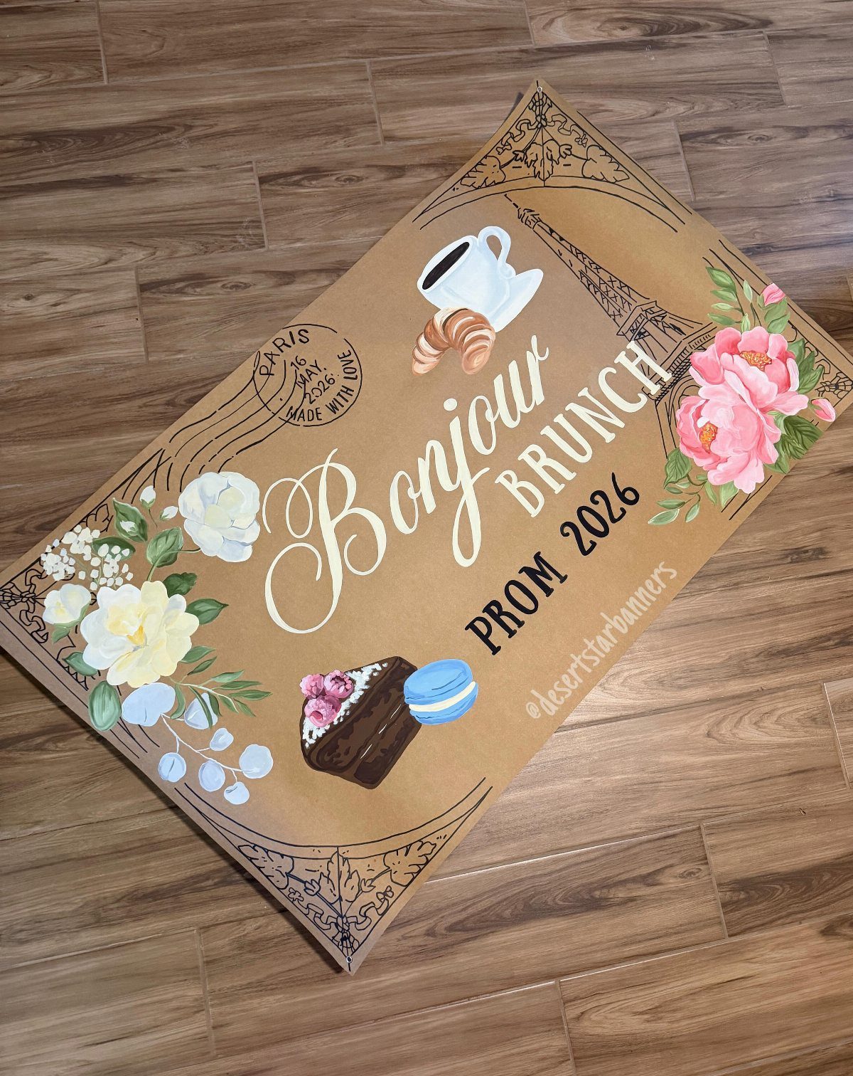 Brown kraft paper banner for a prom brunch with floral illustrations and text.