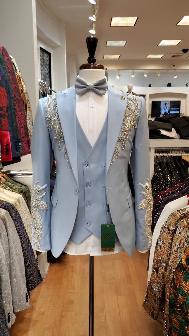Light blue three-piece suit with silver embroidery on a mannequin in a store