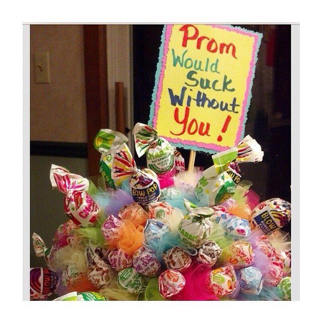 Blow Pop lollipop bouquet with a sign saying Prom Would Suck Without You!