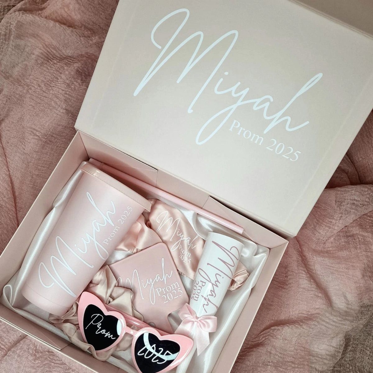 Personalized pink prom gift box with tumbler, sunglasses, and Prom 2025 lettering