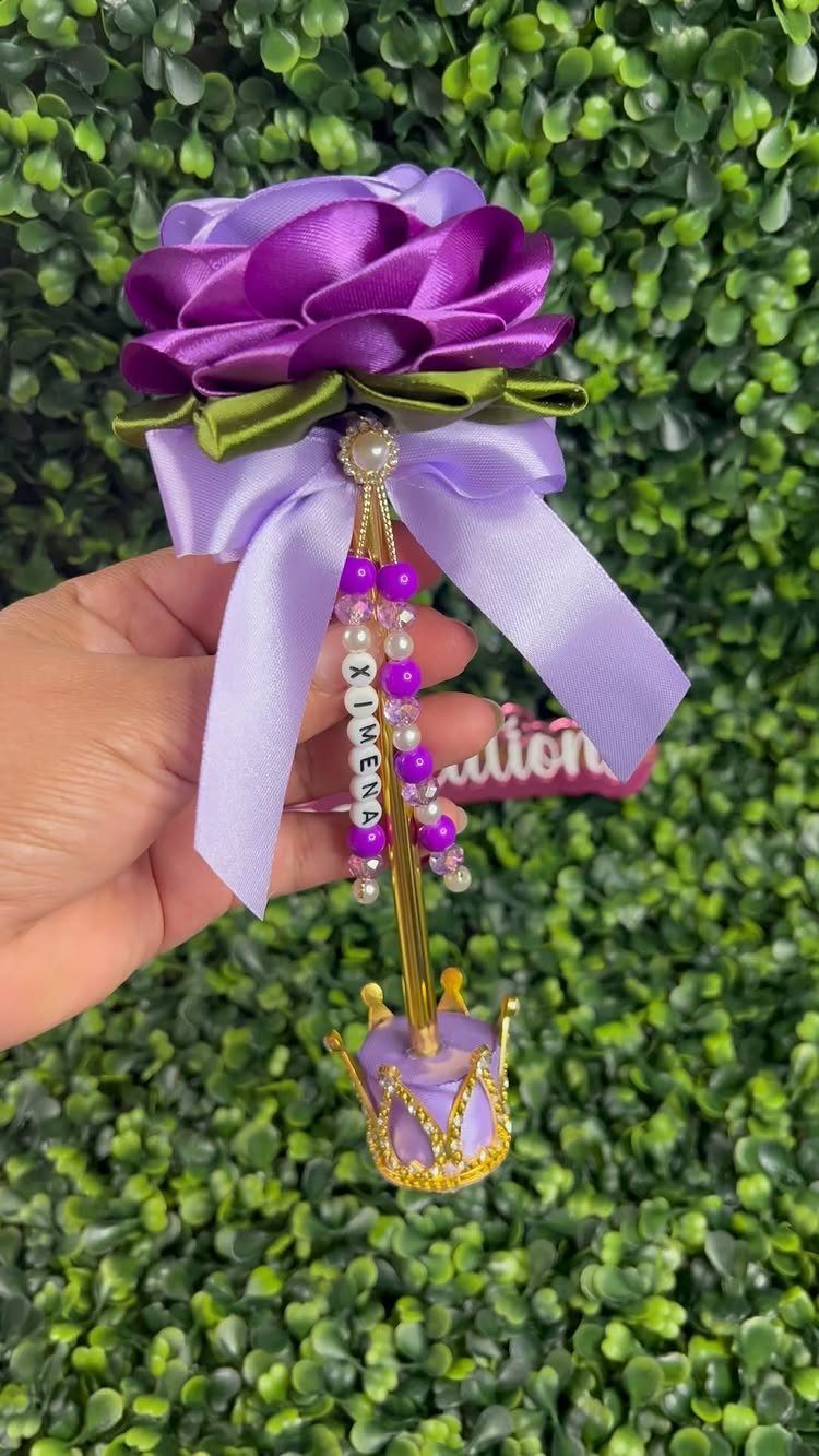 Purple satin rose wand with a gold crown and personalized name beads.