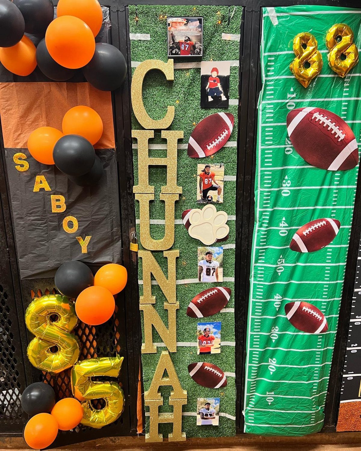 Decorated locker with football theme, orange and black balloons, and gold glitter letters.
