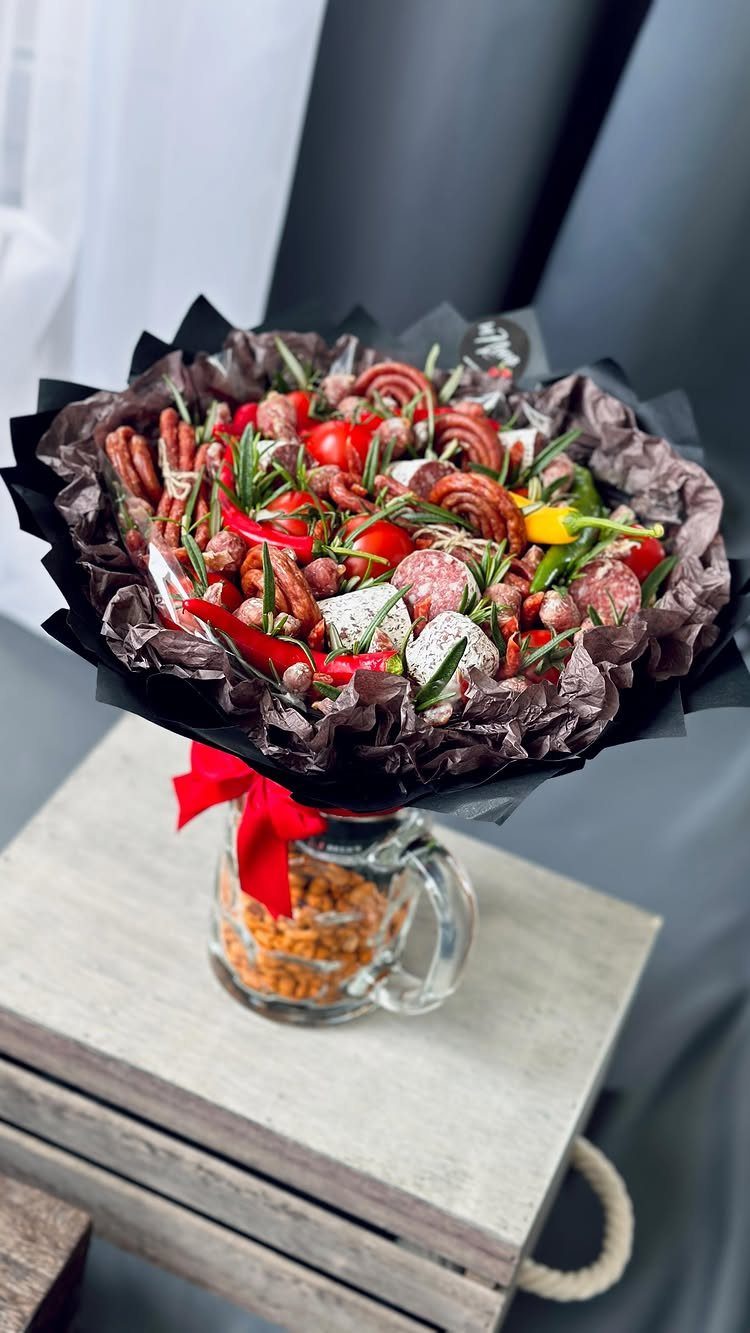 Gourmet meat and snack bouquet with sausages and pretzels in a glass jar