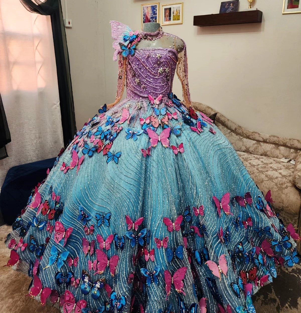 Voluminous ball gown with purple sequined bodice and blue butterfly adorned skirt