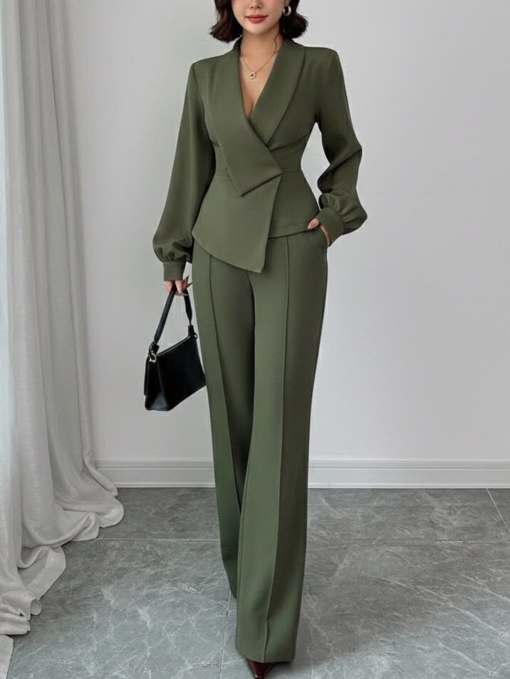Woman wearing a tailored olive green pant suit with a black handbag
